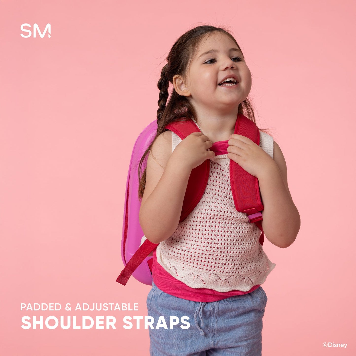 Child wearing bright fuchsia Getaway Kids Backpack with padded straps against pale pink background