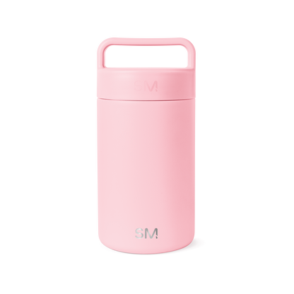 Soft pale pink ceramic jar with lid against white background